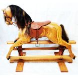 A 4' Relko rocking horse in natural laminated finish, set on a safety rocker - easy catch to the