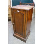 A late Victorian mahogany pot cupboard with spindle back rail and patented and dated latch, set on