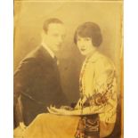 A framed 1920's part tinted photograph, depicting Fred and Adele Astaire, with dedication ink text -