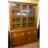 A 5' 6" Victorian stained pine two part dresser with four shelf glazed top over a base with two deep