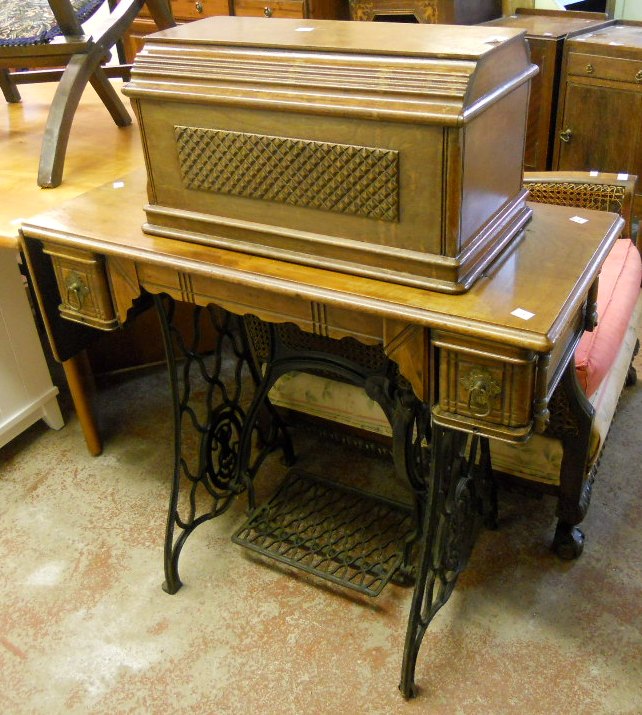 A Singer treadle sewing machine, No. 11417763, with tools, booklets and oak cover