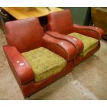 A pair of Art Deco armchairs with studded red floral rexine upholstery, wide arm rests and fitted