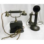 A vintage metal candlestick telephone with bakelite speaker and a vintage Ericsson pillar