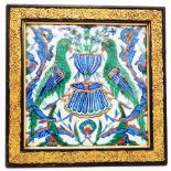 A 9 1/2" square Ottoman Empire Iznik fritware pottery tile with parrots flanking a pedestal fountain