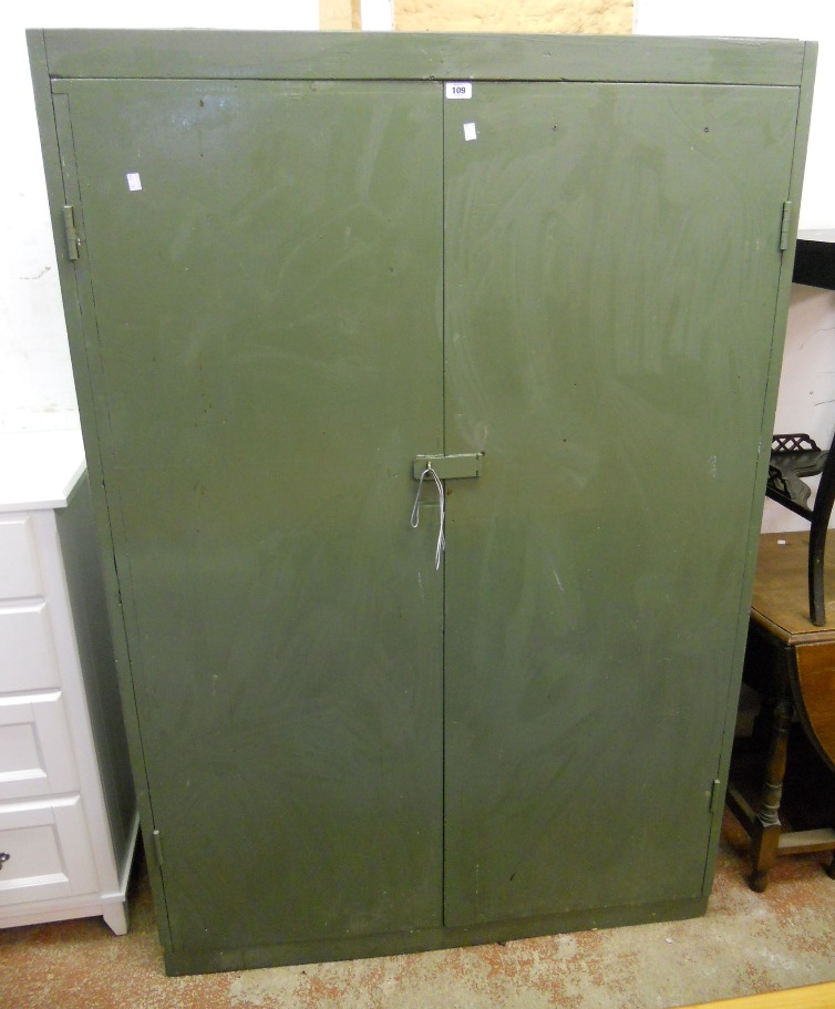 A 3' 11" green painted wooden cupboard with five shelves enclosed by a pair of latch locking doors -