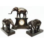 A 1930's patinated spelter elephant pattern clock garniture, comprising central thirty hour