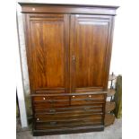 A 4' 3" Edwardian walnut linen press with four slides enclosed by a pair of panelled doors over