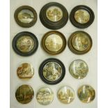 A collection of framed and unframed antique pot lids, including country scenes, dogs, etc.