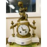 A 19th Century French ornate gilt spelter and white marble cased mantel clock surmounted by a figure