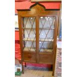 A 35" Edwardian inlaid mahogany display cabinet with Oriental style pediment and material lined