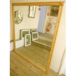 A moulded ash framed wall mirror with bevelled plate - 4' 3" x 4' 11"