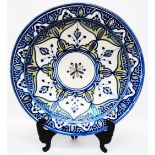 A 16" Moroccan terracotta charger with Safi blue and cream decoration and text to base
