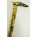 An early 20th Century carved horn vertebrae style walking stick with head pattern handle