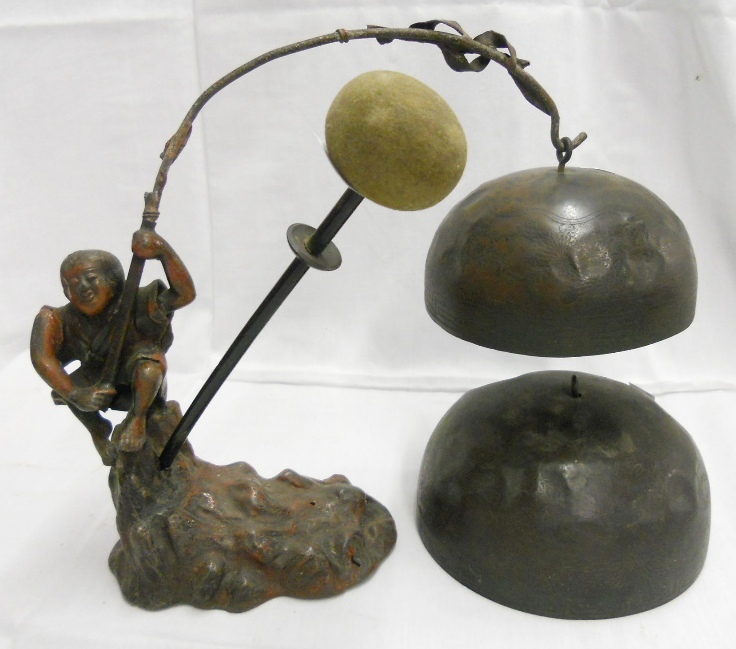 An Oriental painted spelter gong stand in the form of a fisherman holding a rod, the two 5" and 6"