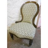 A Victorian mahogany framed spoon back chair with repeat floral and foliate upholstery, set on