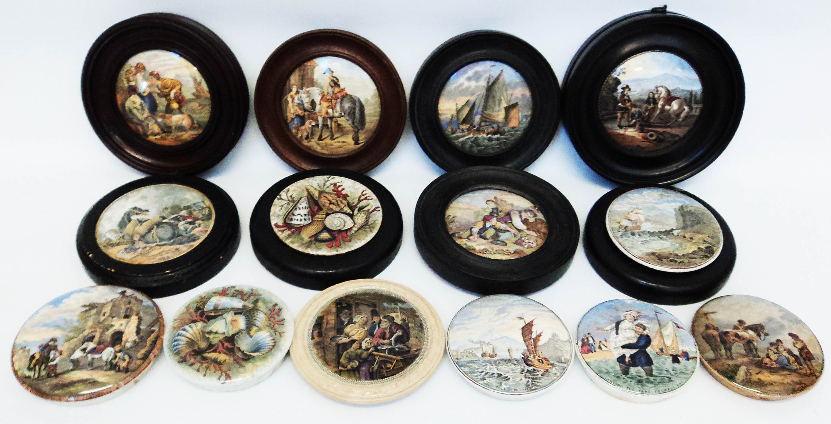 A collection of framed and unframed antique pot lids with scenic decoration, including "War", "I
