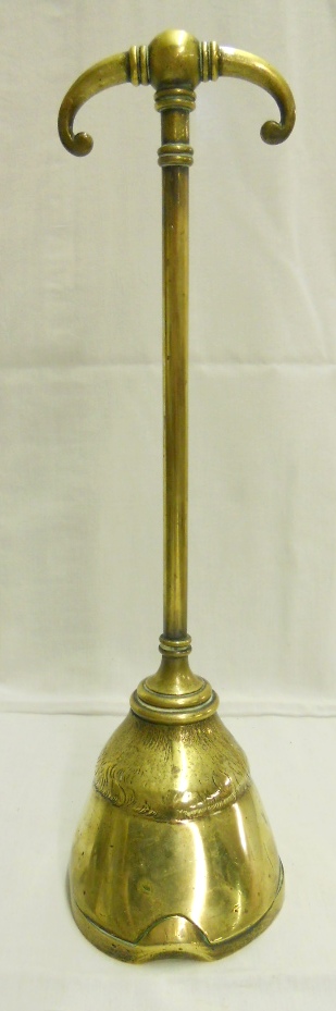 An antique brass long handled doorstop in the form of a horse's hoof, with registration diamond