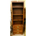 A 24" reproduction campaign style open bookcase with three adjustable shelves over three long