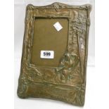 An Arts and Crafts copper mounted picture frame embossed with Native American by a campfire and