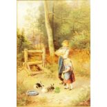 In the manner of Myles Birkett Foster: a gilt framed watercolour depicting two girls feeding rabbits