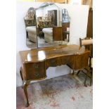 A 4' 20th Century book matched flame mahogany veneered serpentine front knee hole dressing table,