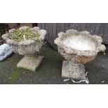 A pair of ornate concrete planters with allover acanthus leaf decoration