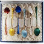 A cased set of six Danish silver gilt coffee spoons with different coloured enamel decoration