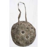 A 19th Century Indian maduva (parrying shield) made from thick hide and bound with steel bosses