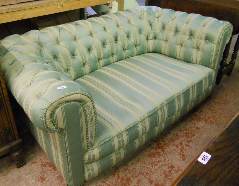 A 5' 8" 1930's Chesterfield settee with green and cream striped button back upholstery