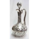 A continental white metal clad bulbous decanter and stopper with foliate scroll decoration - neck
