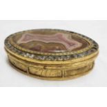 An oval gilt metal pill box with central agate and inset diamante to rim