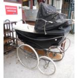 A vintage Silver Cross pram in black livery - interior in need of restoration