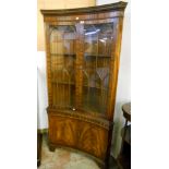 A 36" reproduction mahogany display cabinet of concave design with dentil cornice, Gothic style