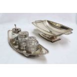 A silver topped cut glass condiment set on a silver boat shaped stand - London 1789 - sold with a