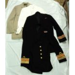 A collection of Royal Navy uniform jackets and trousers belonging to the late Surgeon Vice-Admiral