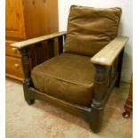 A pair of 1930's stained oak framed reclining armchairs with ratchet ladder backs