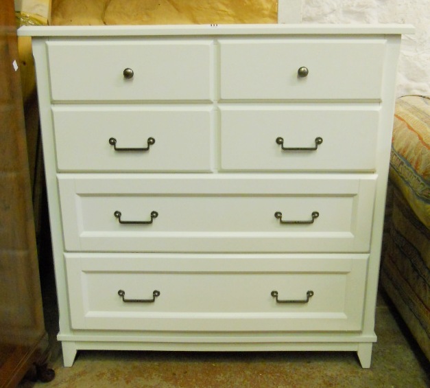 A 3' 5" Laura Ashley Devon chest of four short and two long graduated drawers with all over white