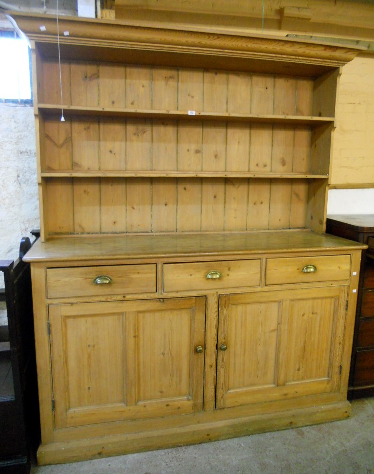 A 6' 5" Victorian waxed pine two part dresser with two shelf open plate rack over a base with