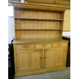 A 6' 5" Victorian waxed pine two part dresser with two shelf open plate rack over a base with