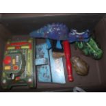 A small case containing various tin plate toys