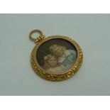 AN EARLY 20TH CENTURY PICTURE LOCKET, depicting two children within a scrolling floral surround to