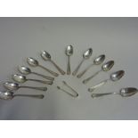 A SET OF TWELVE STERLING SILVER TABLE SPOONS, marked sterling (and a pair of sugar tongs) (