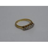 A FIVE STONE DIAMOND RING, the graduated diamonds to the plain tapered band, stamped 18ct, PLAT,