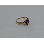 A 9CT GOLD GARNET RING, two stones defic