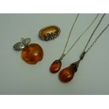 A GROUP OF AMBER JEWELLERY, to include two brooches and two pendants