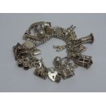 A SILVER CHARM BRACELET, comprising of t