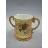 A ROYAL WORCESTER BLUSH IVORY LOVING CUP, florally decorated, height 15cm (restorations)
