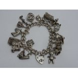 A SILVER CHARM BRACELET, comprising of s