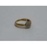 A 9CT GOLD DIAMOND CLUSTER RING, with si