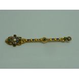 A RUSSIAN GILT METAL PIN, with gem set and seed pearl detail, with enamel detail, marks to pin